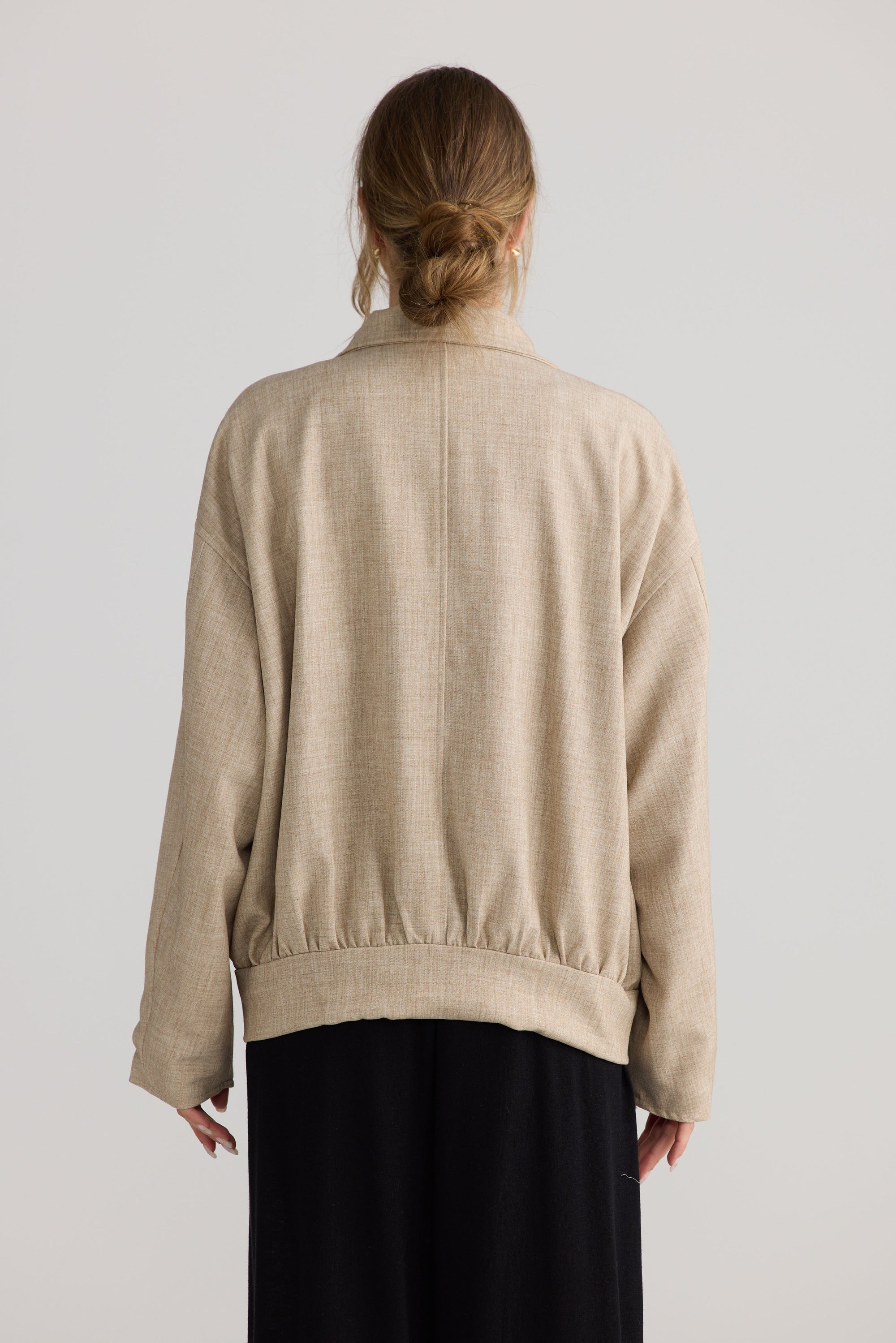 Model wearing Edie Jacket in stone, styled for everyday wear.