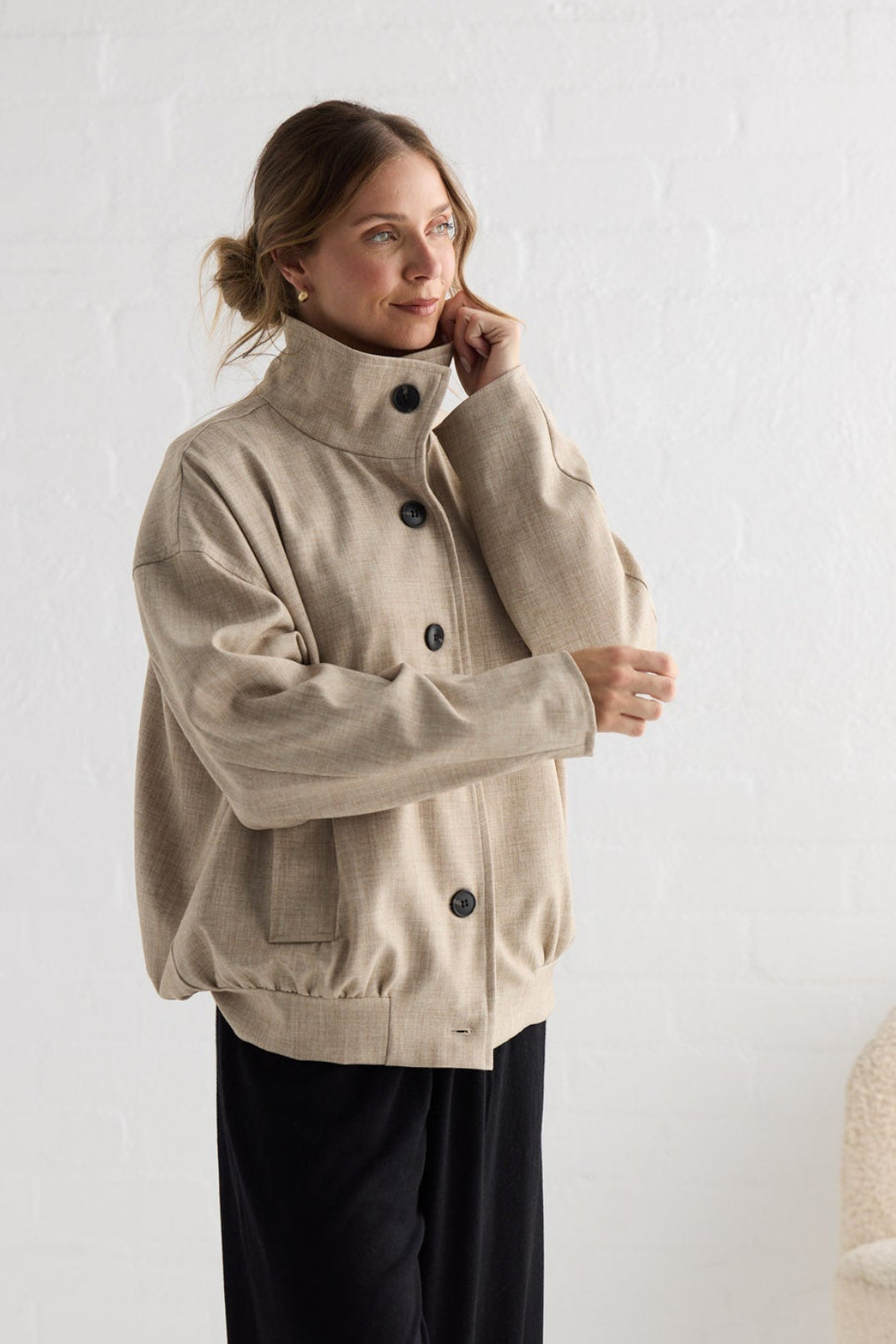 Campaign image of model wearing Edie Jacket in stone.