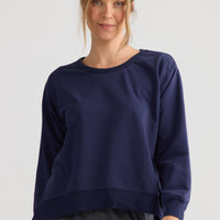 Model wearing Faye Lounge Jumper in navy.