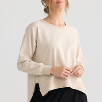 Model wearing Faye Lounge Jumper in oat.