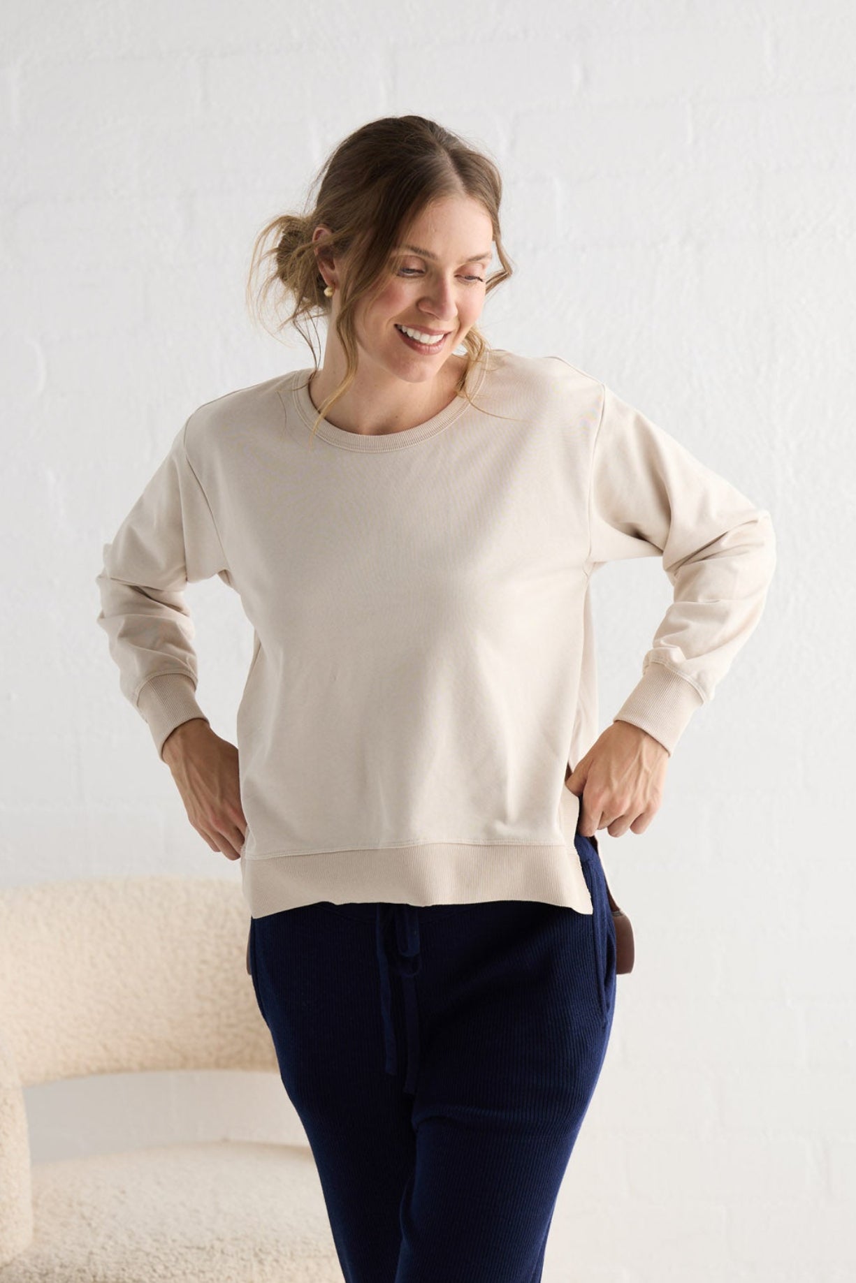 Campaign image of model wearing Faye Lounge Jumper in oat.