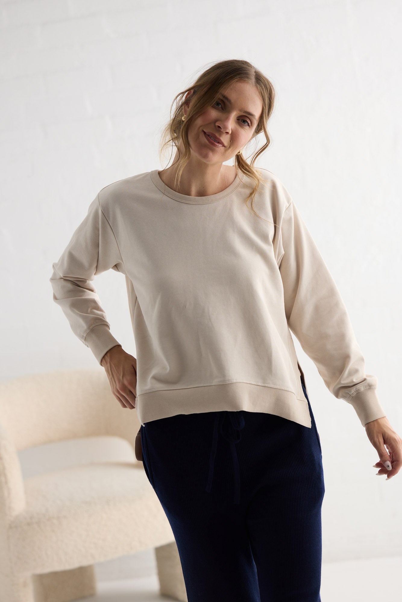 Campaign image of model wearing Faye Lounge Jumper in oat.