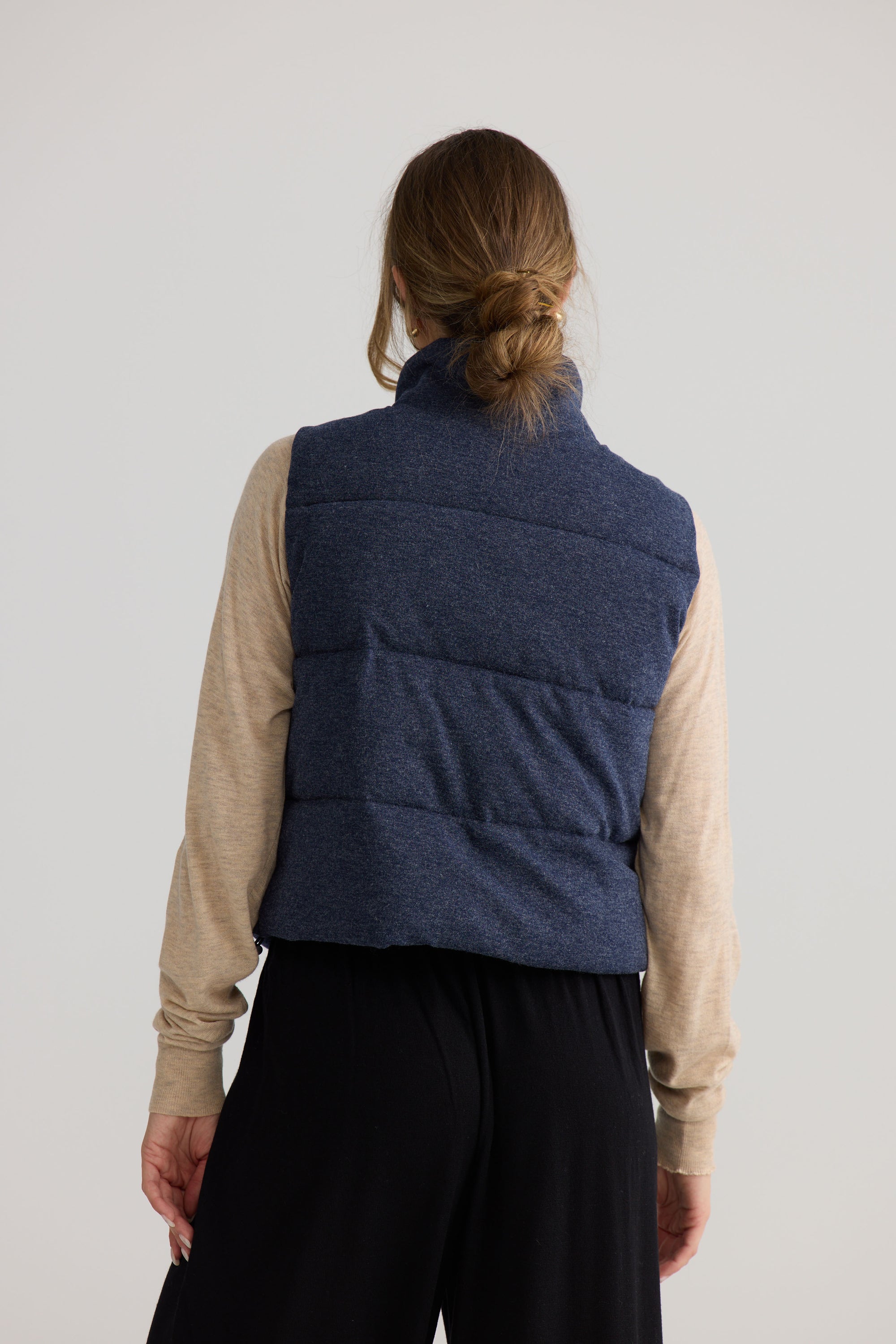 Model wearing Tate Puffer Vest in navy, styled for everyday wear.