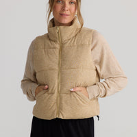 Model wearing Tate Puffer Vest in oat, styled for everyday wear.