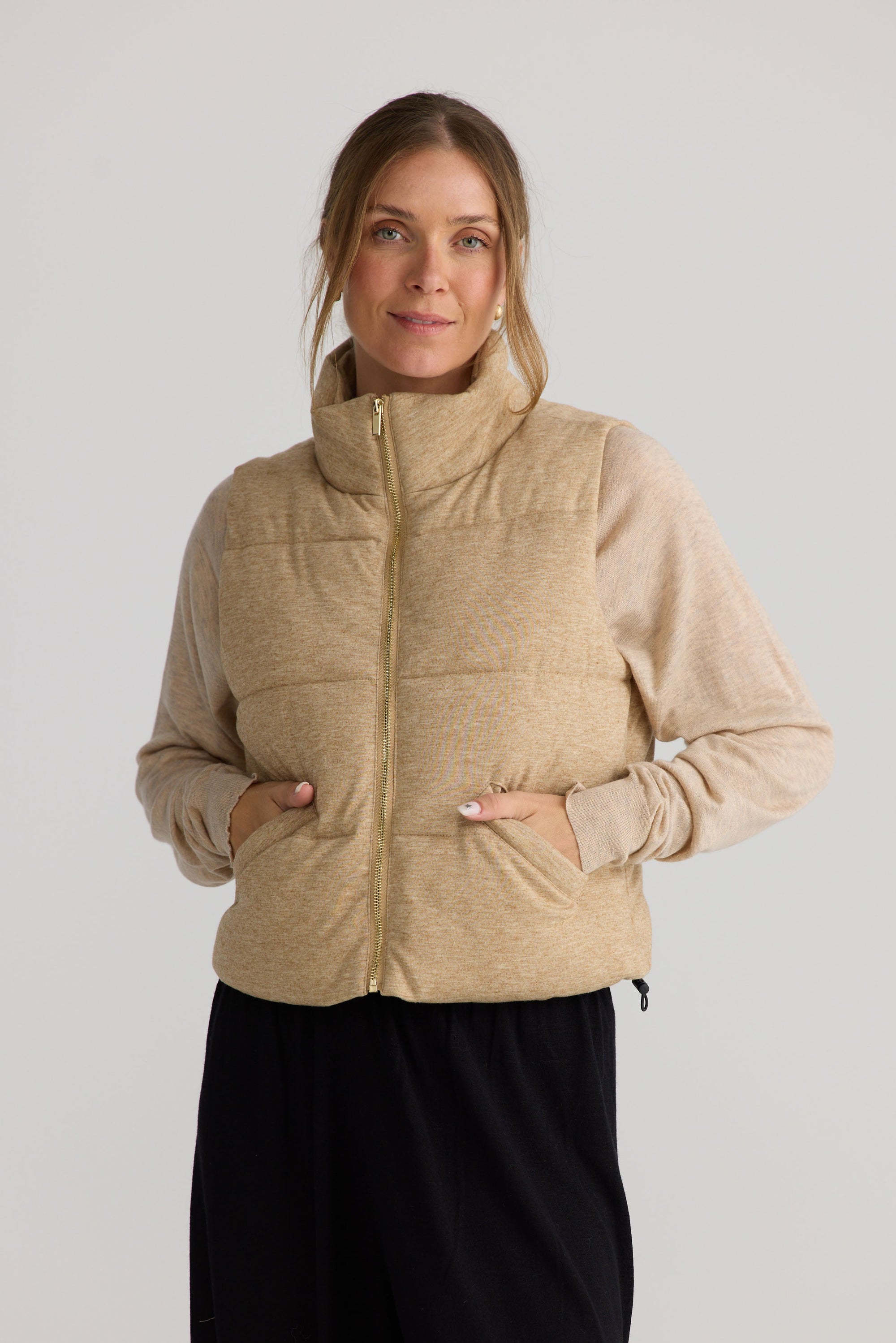 Model wearing Tate Puffer Vest in oat, styled for everyday wear.