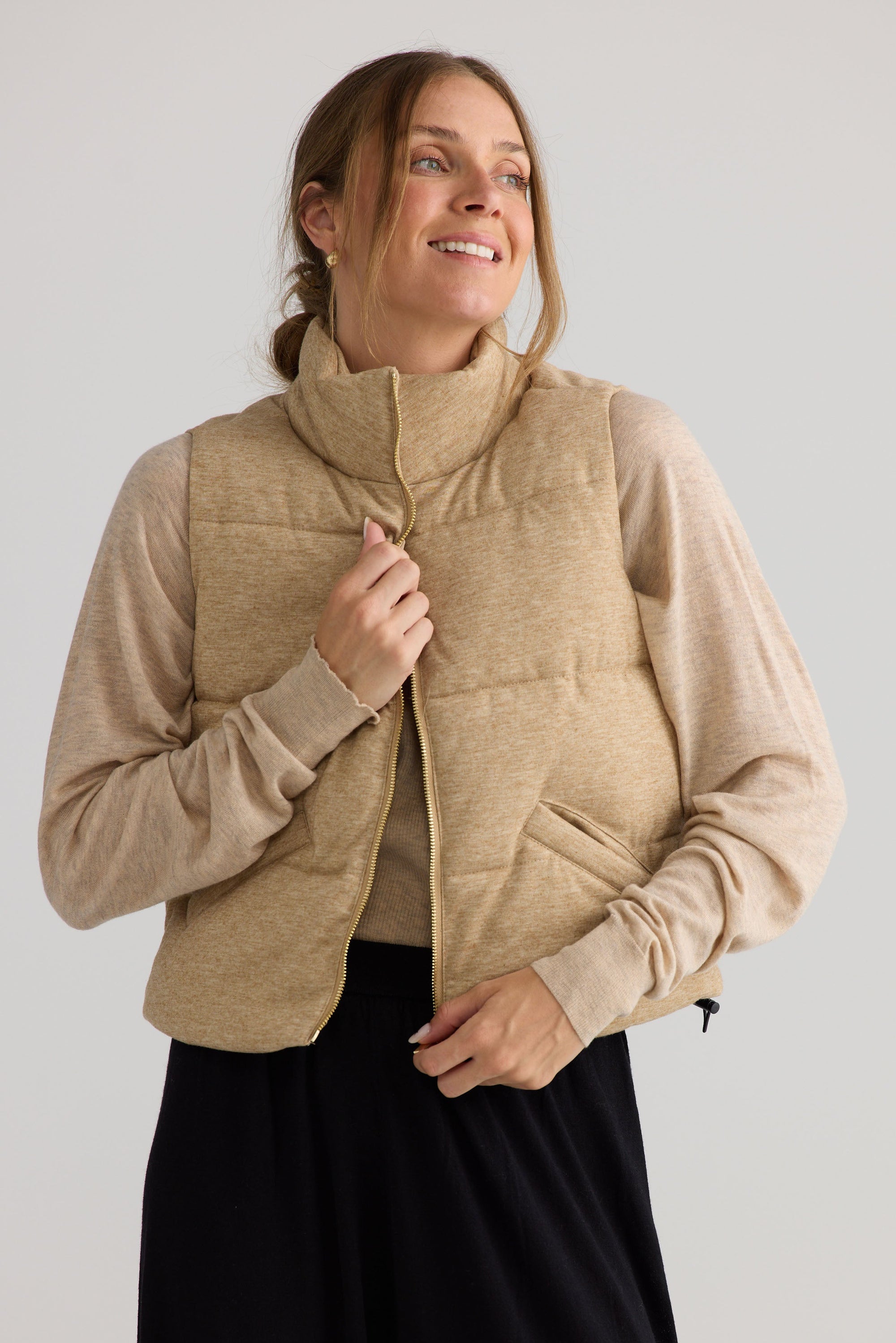 Tate Puffer Vest in oat, shown on model.