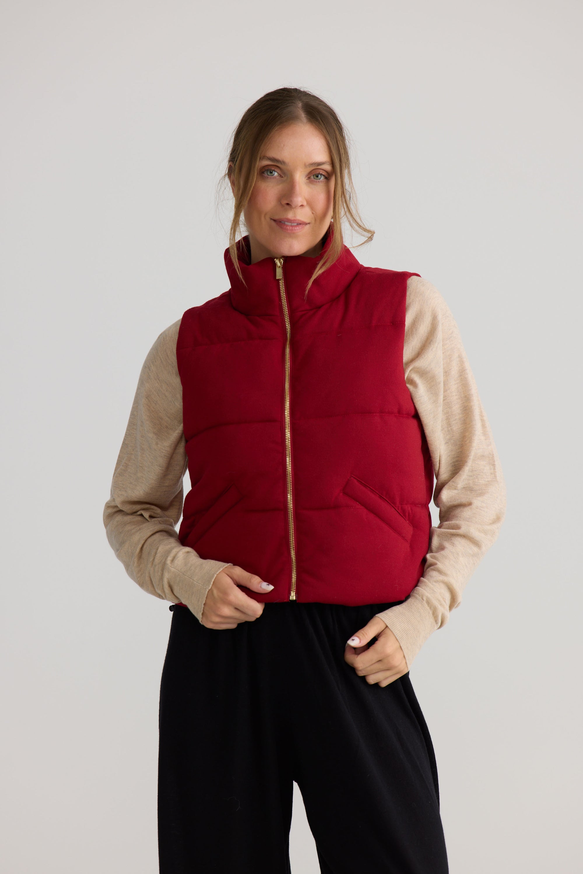 Tate Puffer Vest in red, styled with a relaxed outfit.