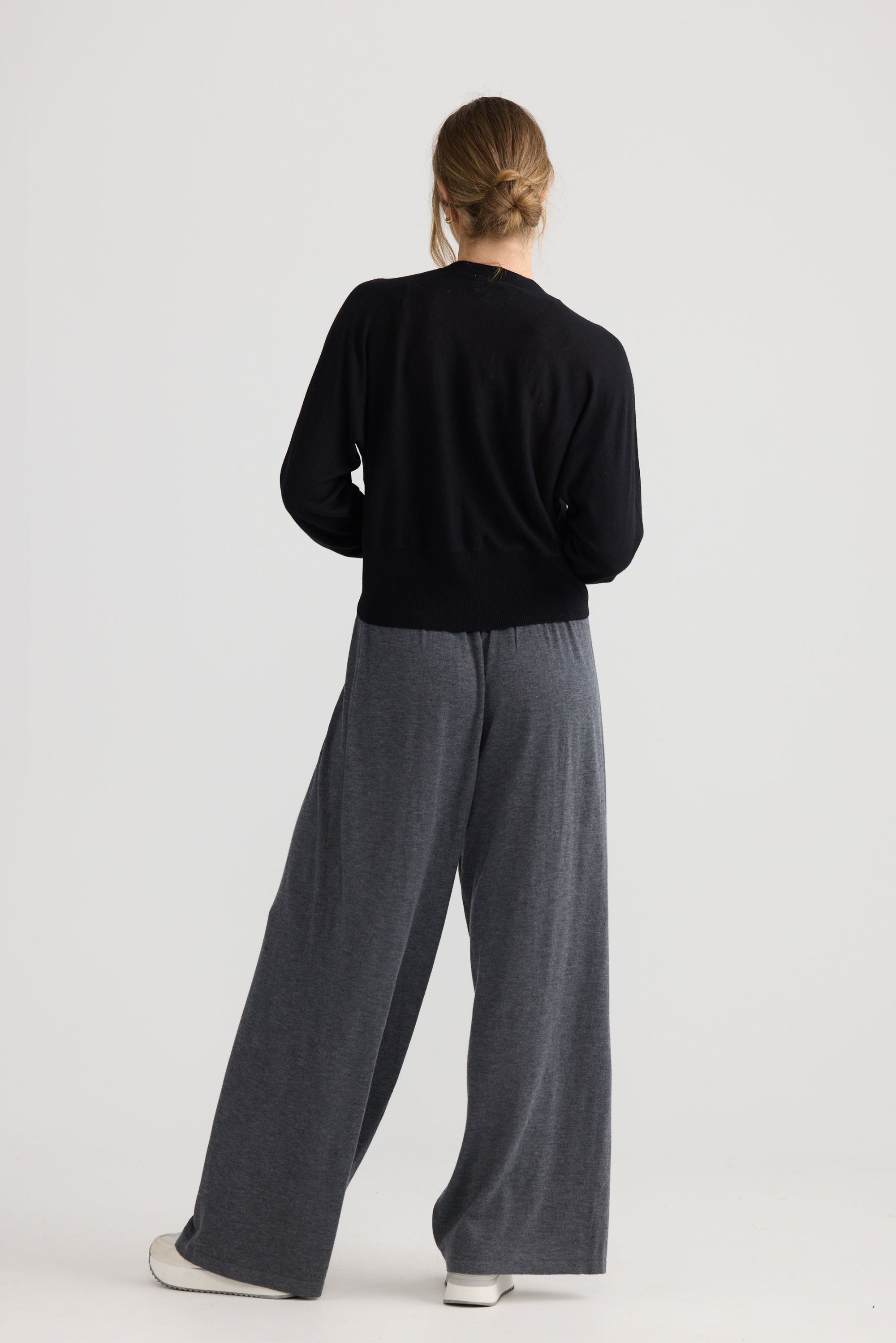 Model wearing Stillness Knit in black.