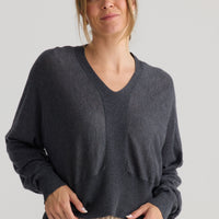 Model wearing Stillness Knit in charcoal.
