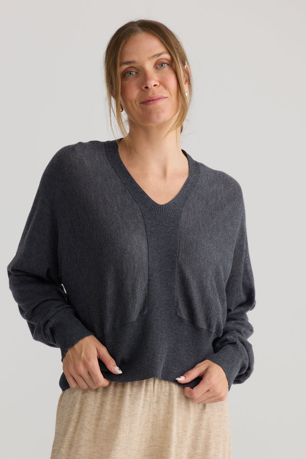 Model wearing Stillness Knit in charcoal.