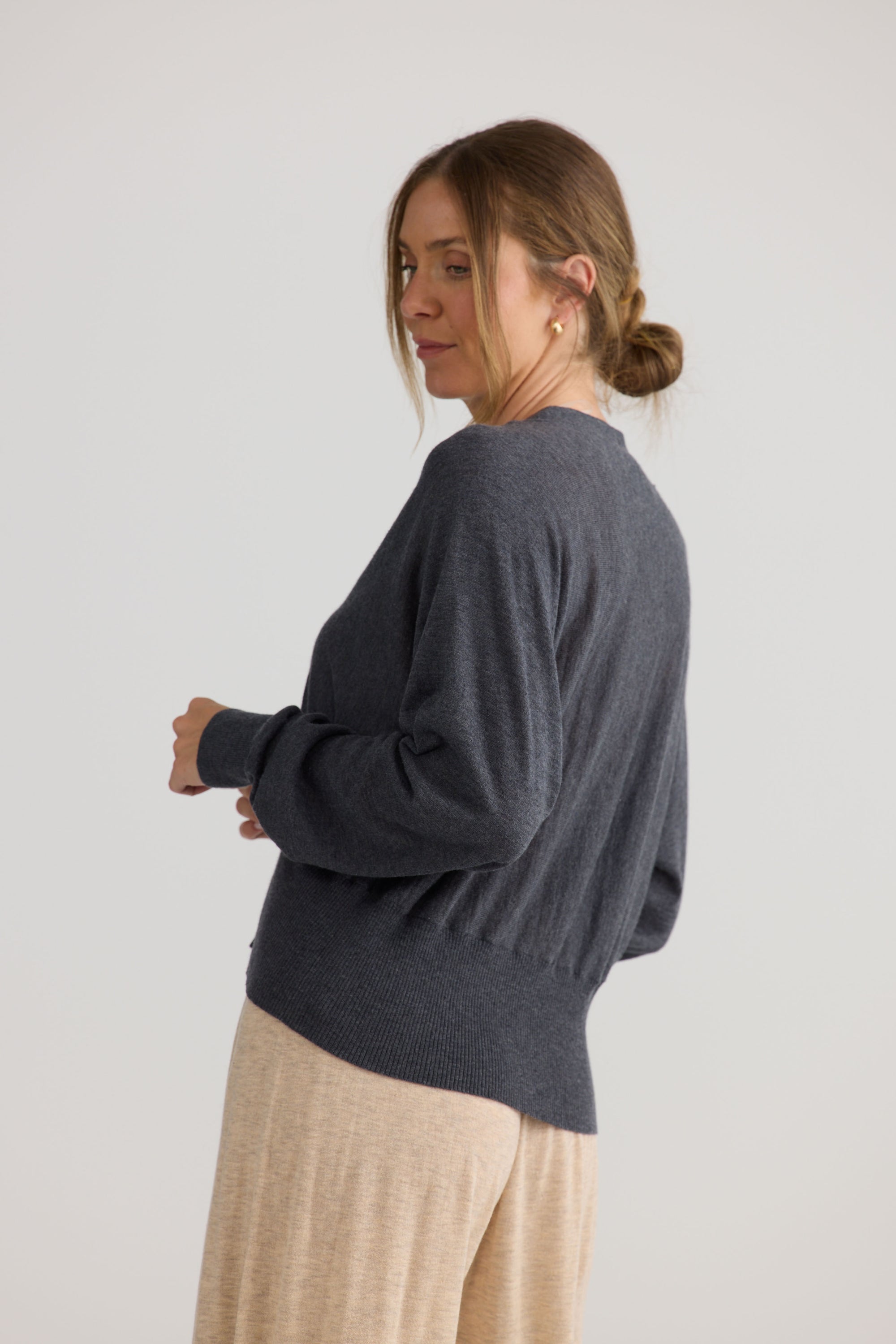 Model wearing Stillness Knit in charcoal, styled for everyday wear.