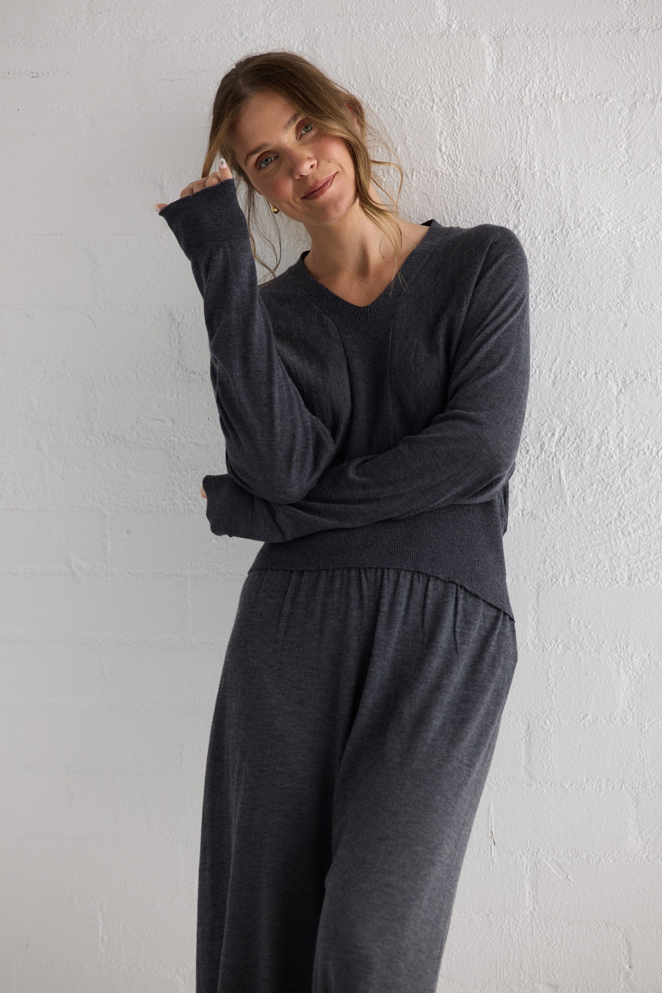 Campaign image of model wearing Stillness Knit Pant in charcoal.