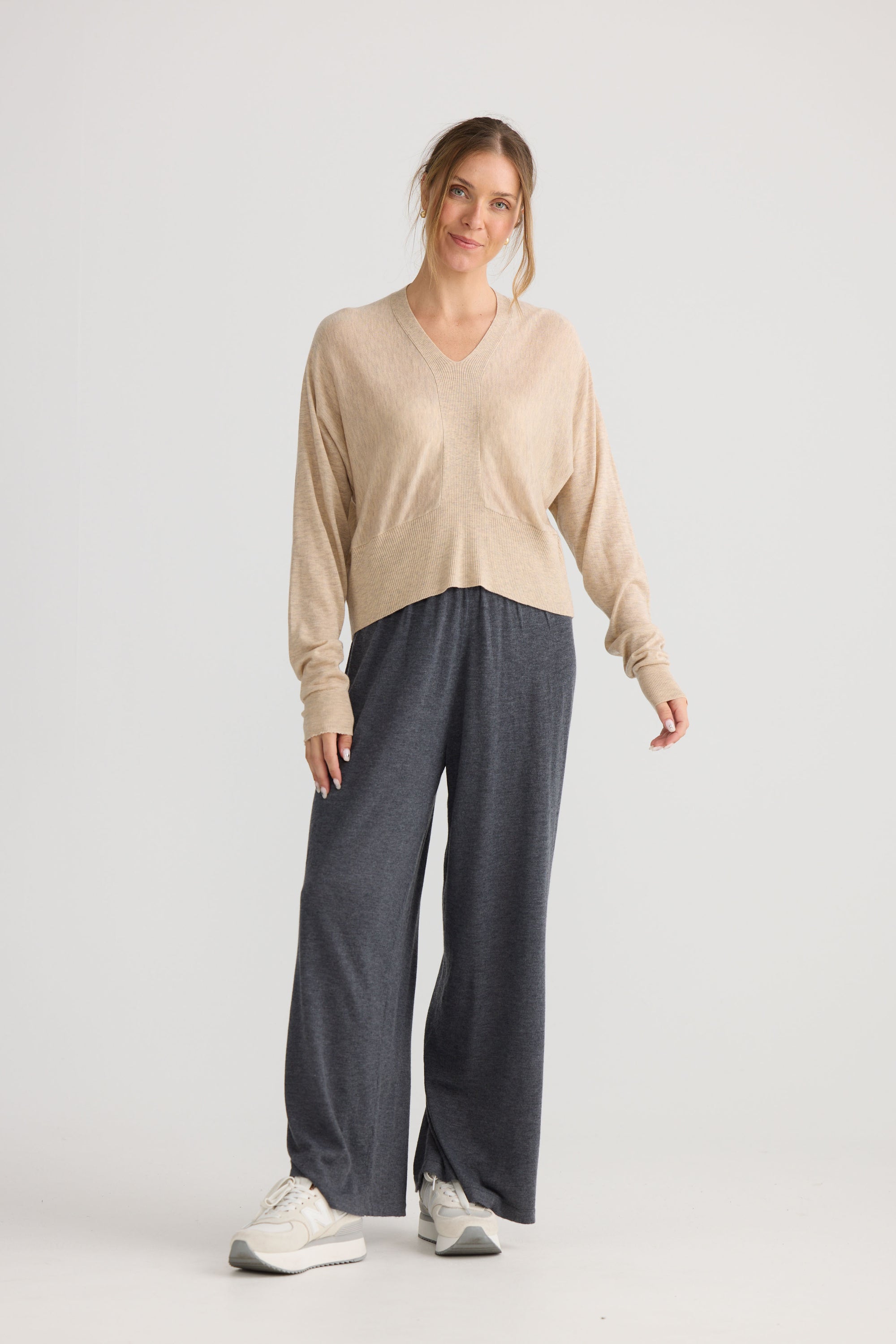 Model wearing Stillness Knit in oat, showing knit texture.