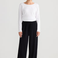 Stillness Knit Pant in black, styled with a relaxed outfit.