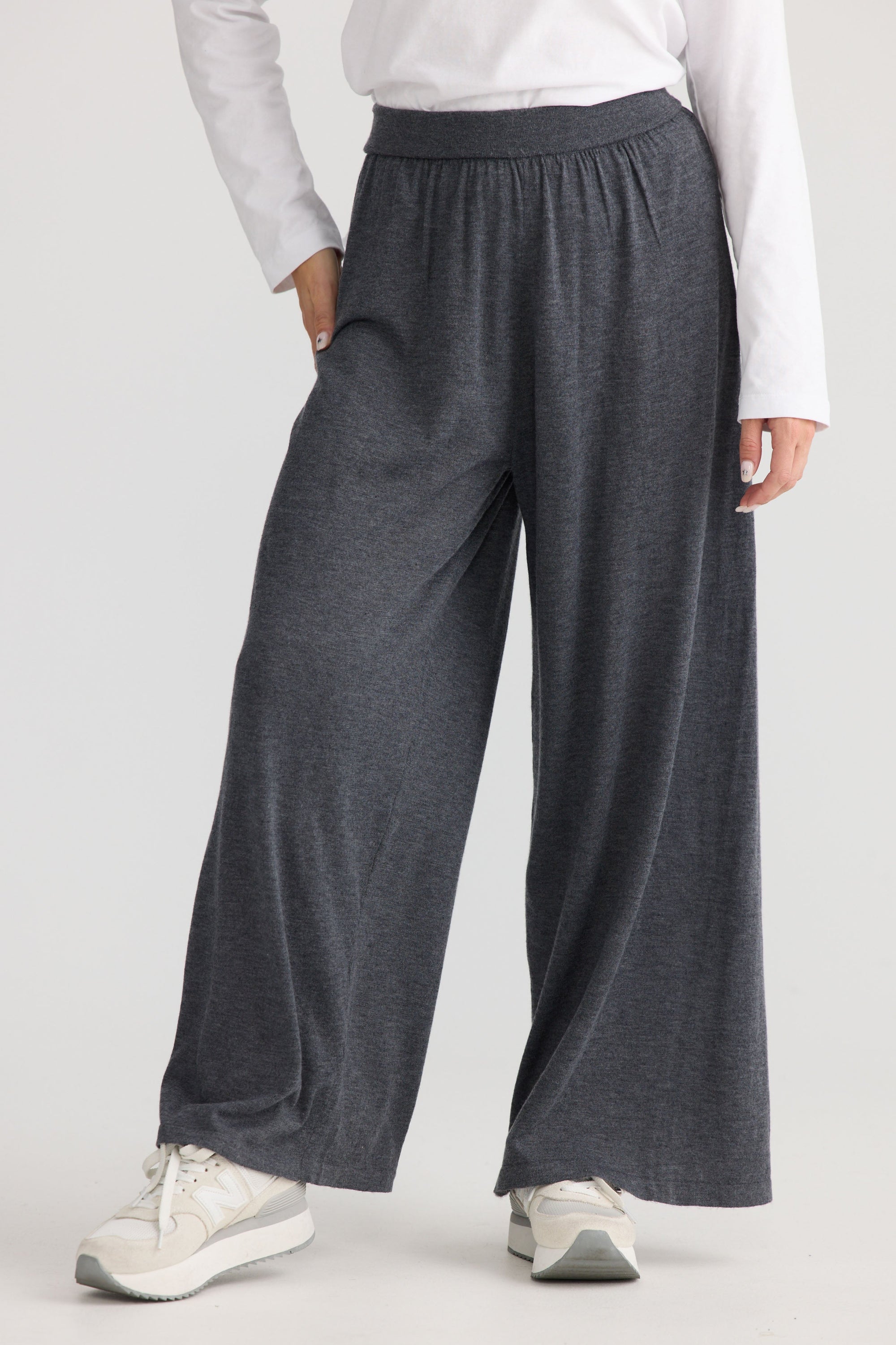 Model wearing Stillness Knit Pant in charcoal.