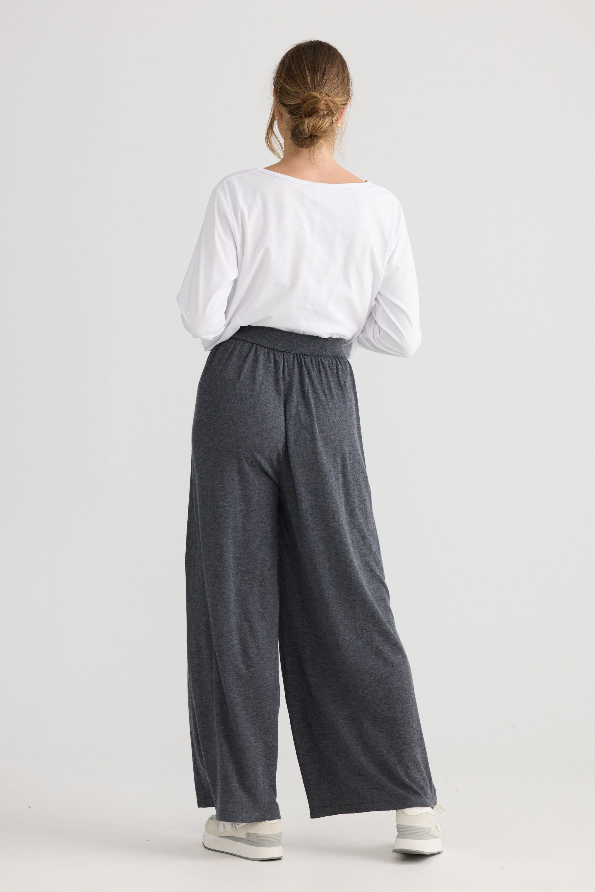 Model wearing Stillness Knit Pant in charcoal, styled for everyday wear.