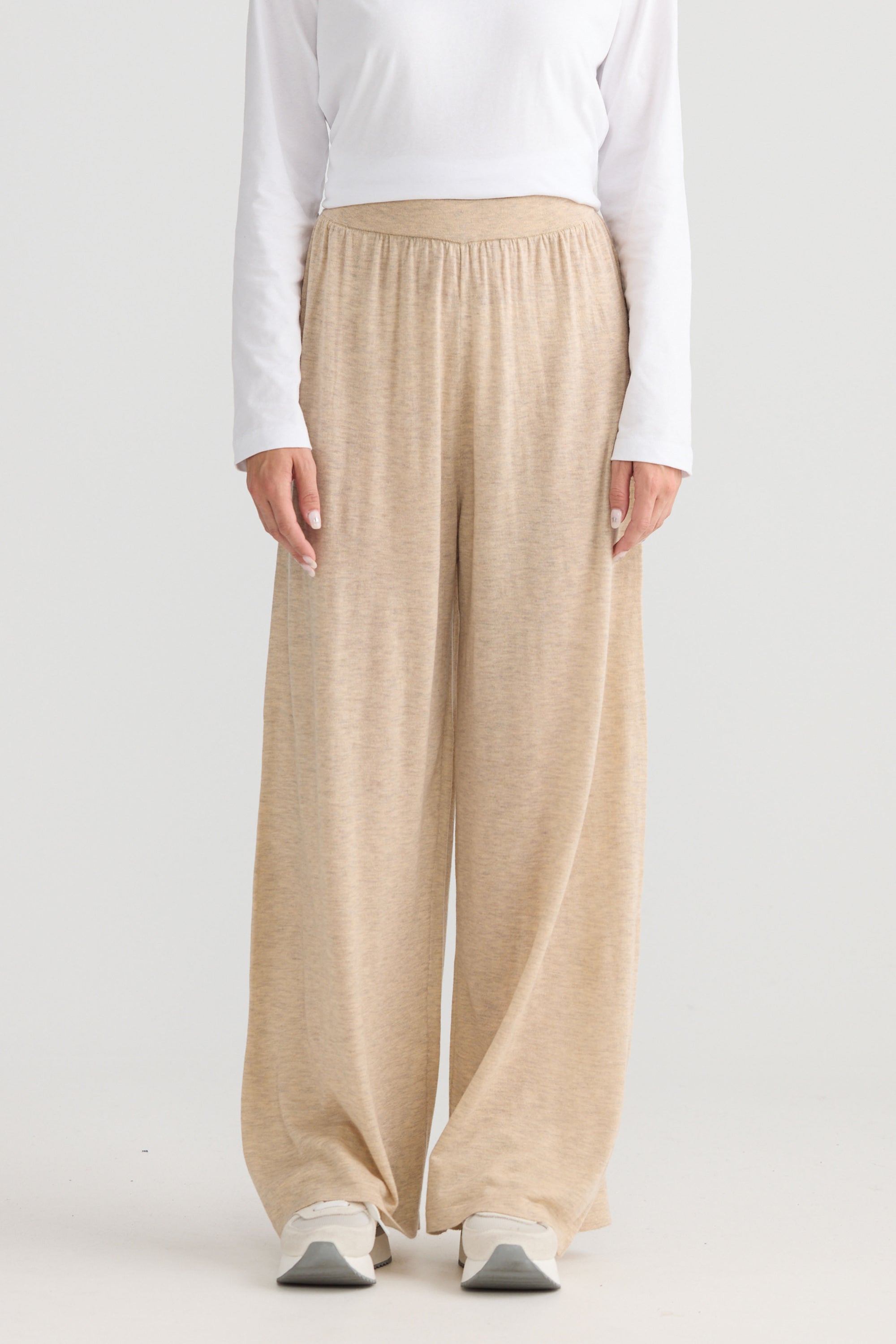 Model wearing Stillness Knit Pant in oat, showing relaxed leg shape.